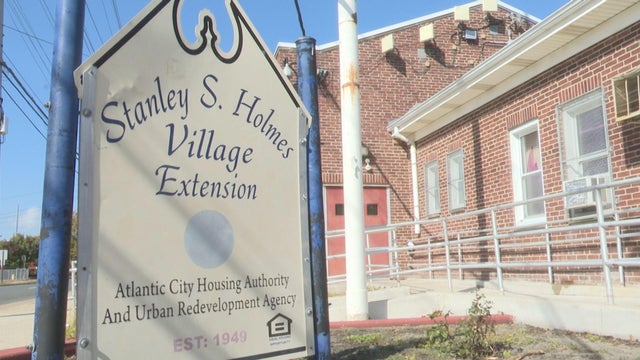 A sign for the Stanley S. Holmes Village housing complex 