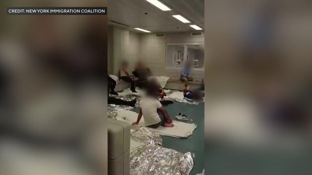People sitting on towels and blankets on the floor 